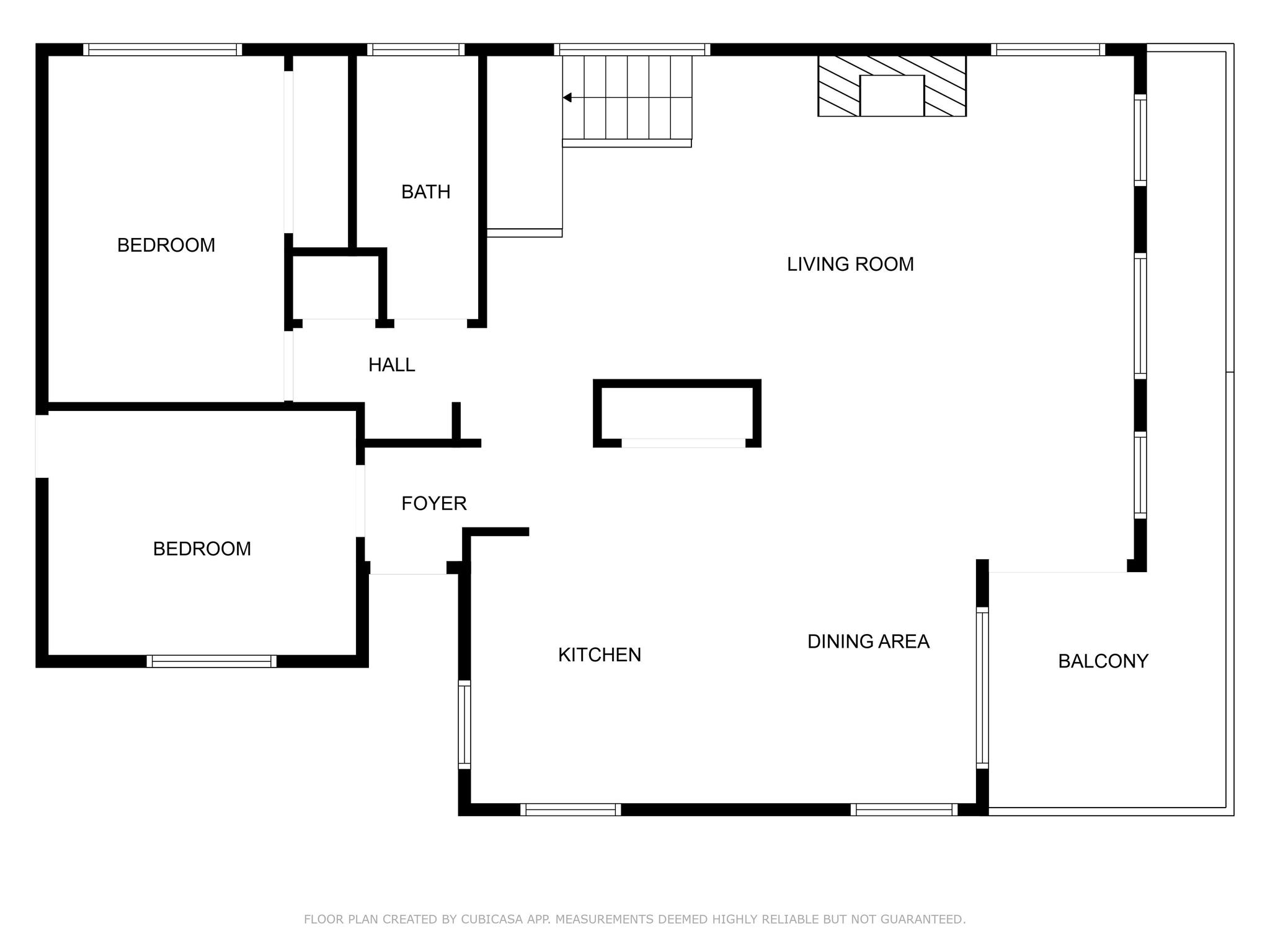Lower level floor plan of Buccaneer House with living room, kitchen, dining area, two bedrooms, and balcony